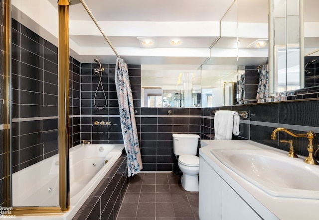 full bathroom featuring tile patterned floors, vanity, tile walls, toilet, and shower / bath combo