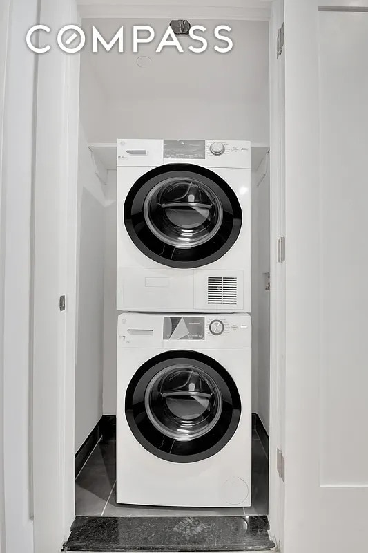 laundry room featuring laundry area and stacked washer / dryer