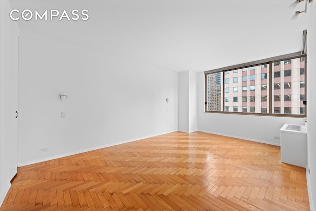 spare room with baseboards
