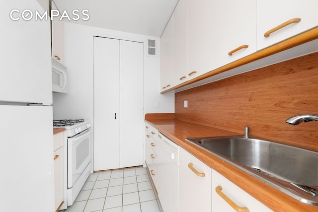 kitchen with white appliances and white cabinets