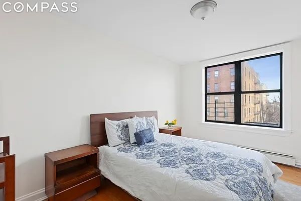 bedroom with wood-type flooring and multiple windows