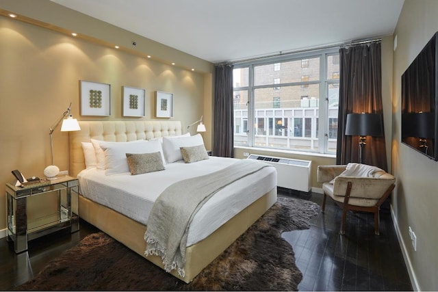 bedroom with dark hardwood / wood-style flooring and radiator