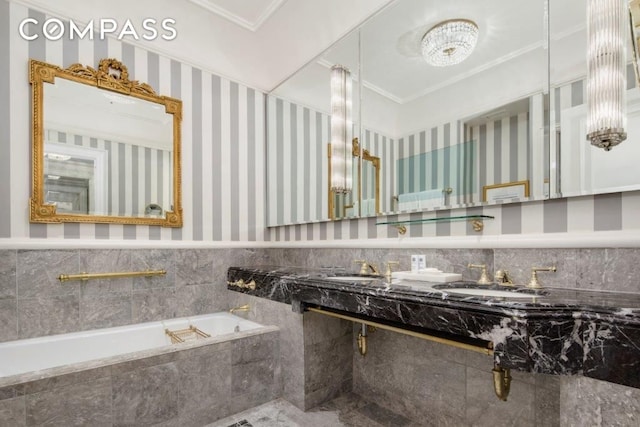 2 E 55th St Unit 1036W34, New York City, NY 10022 - bathroom with ornamental molding, a sink, a wainscoted wall, and tile walls