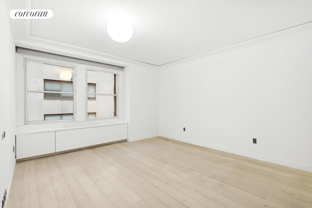 empty room with light hardwood / wood-style flooring