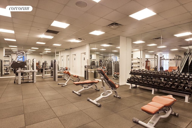 exercise room featuring a drop ceiling