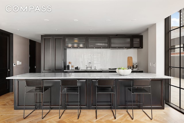 bar featuring backsplash and a sink