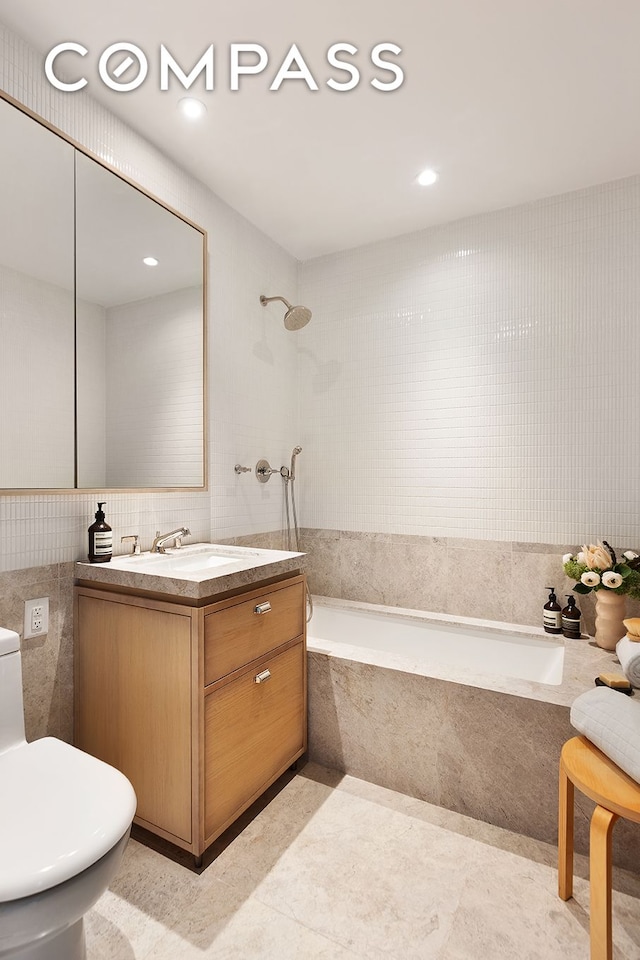 full bath featuring tile patterned floors, tile walls, toilet, and vanity