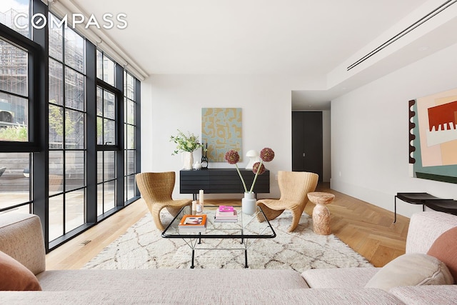 living room featuring expansive windows and baseboards