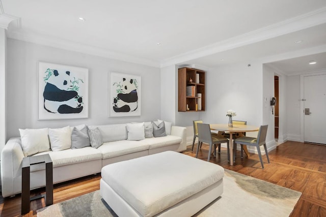 living room with hardwood / wood-style floors and crown molding