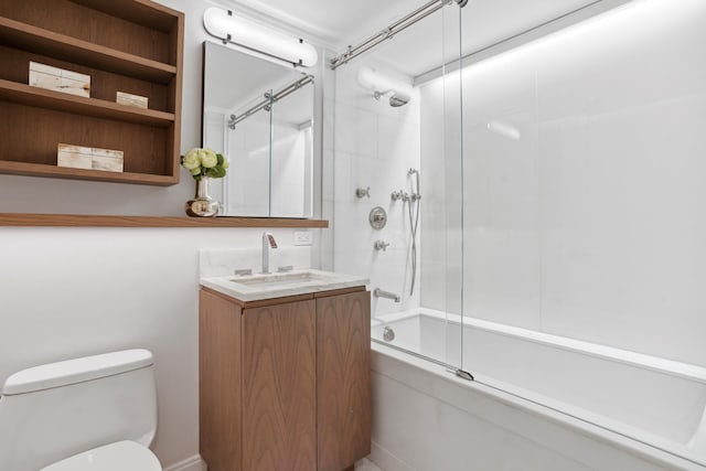 bathroom featuring toilet, combined bath / shower with glass door, and vanity