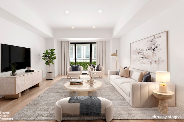 living area featuring light wood finished floors and baseboards