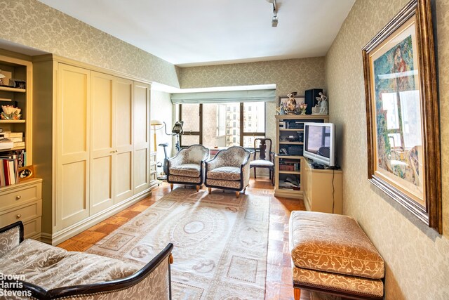 425 E 58th St Unit 14D, New York City, NY 10022 - sitting room with wallpapered walls and wood finished floors
