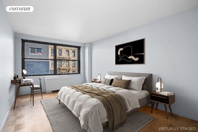 bedroom with radiator heating unit, visible vents, and baseboards