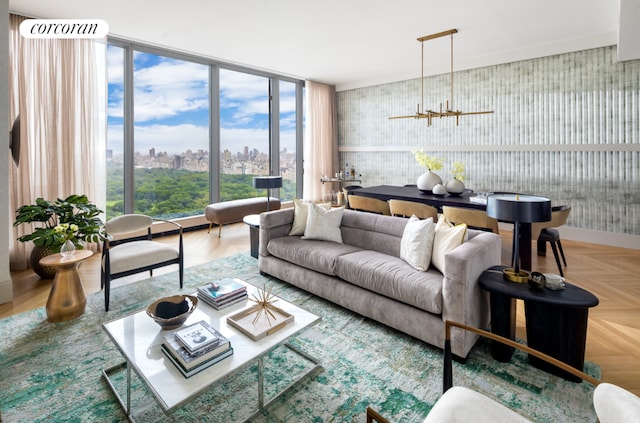 living room featuring a wall of windows, a notable chandelier, and parquet floors