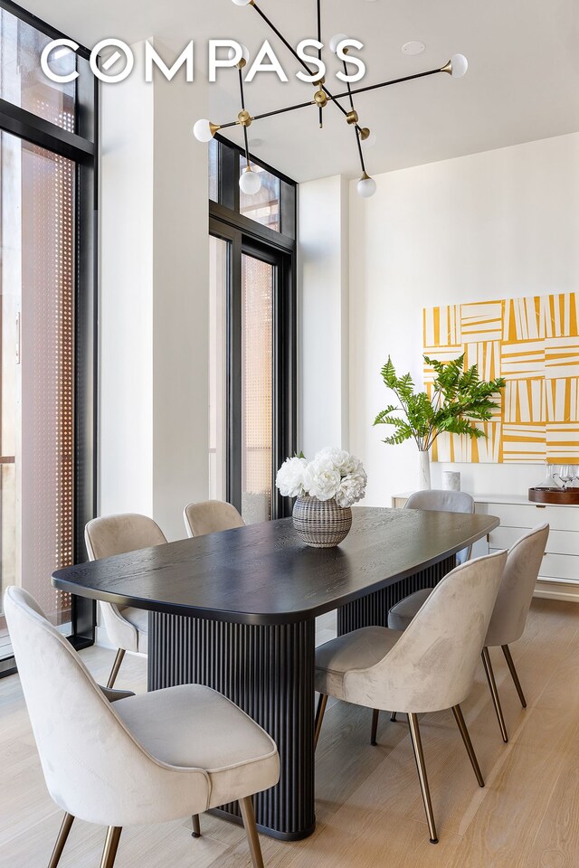 dining space with light wood-style floors and expansive windows