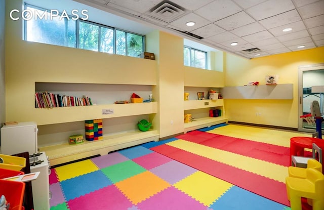 playroom with a paneled ceiling