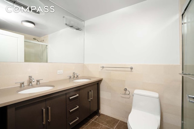 bathroom featuring a sink, toilet, a stall shower, and tile patterned floors