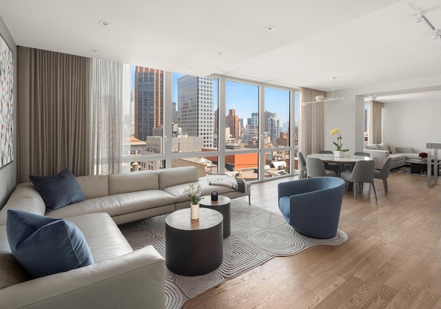 39 E 29th St Unit 25A, New York City, NY 10016 - living room with wood finished floors, a view of skyline, and floor to ceiling windows