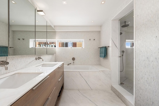 39 E 29th St Unit 25A, New York City, NY 10016 - bathroom featuring a bath, a walk in shower, double vanity, tile walls, and tile patterned flooring