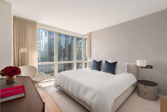 39 E 29th St Unit 25A, New York City, NY 10016 - bedroom with wood finished floors and a wall of windows