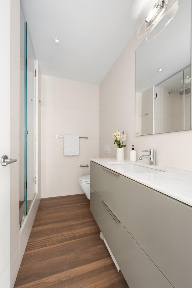 39 E 29th St Unit 25A, New York City, NY 10016 - bathroom featuring vanity, a shower with shower door, and wood finished floors