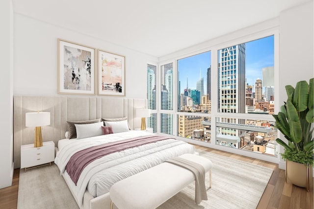 39 E 29th St Unit 25A, New York City, NY 10016 - bedroom featuring wood finished floors, a view of skyline, and wainscoting