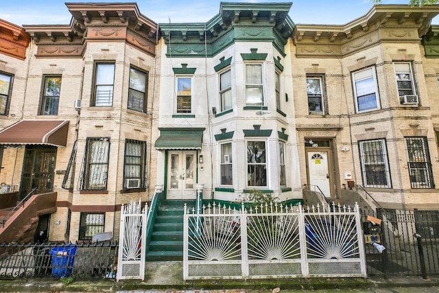 view of property with cooling unit and a fenced front yard