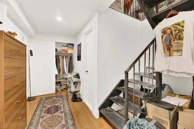 interior space with wood finish floors and recessed lighting