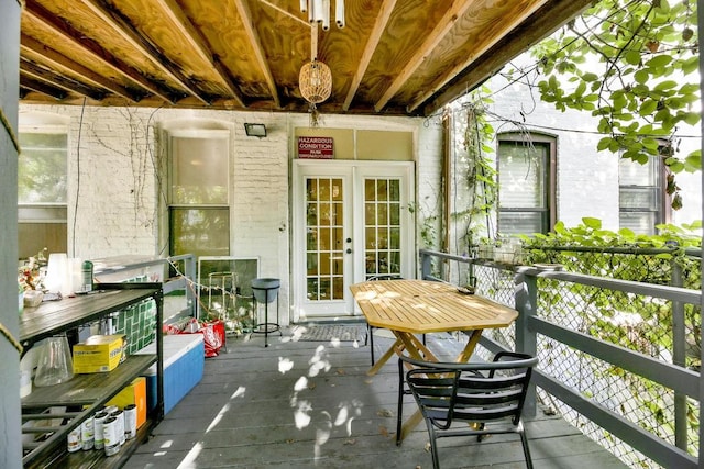 wooden balcony with a wooden deck and french doors