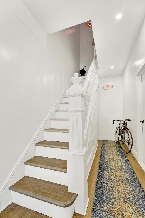 stairs featuring wood-type flooring