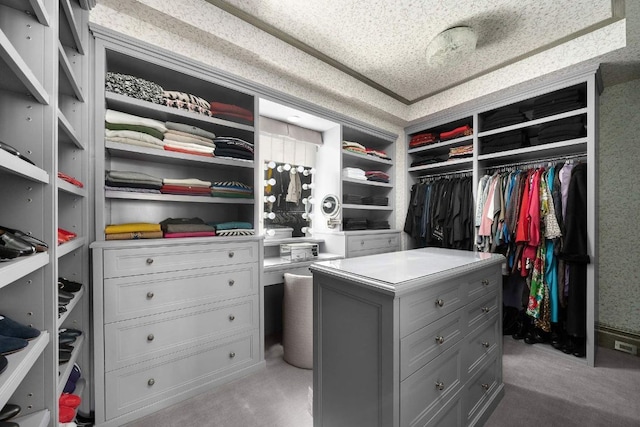 walk in closet featuring light carpet