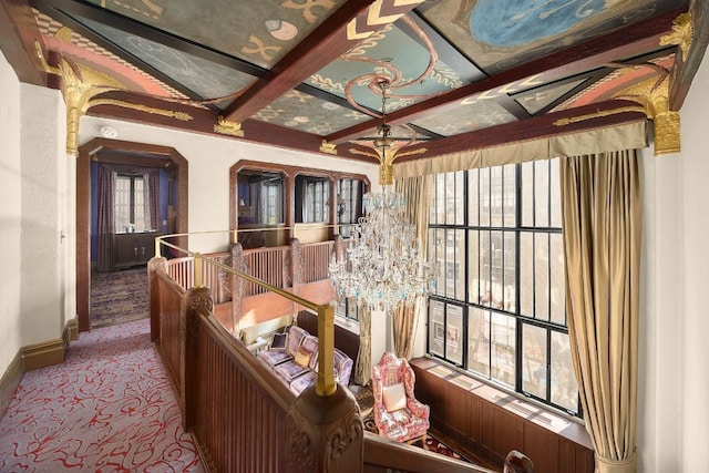 interior space with beamed ceiling, a healthy amount of sunlight, and coffered ceiling