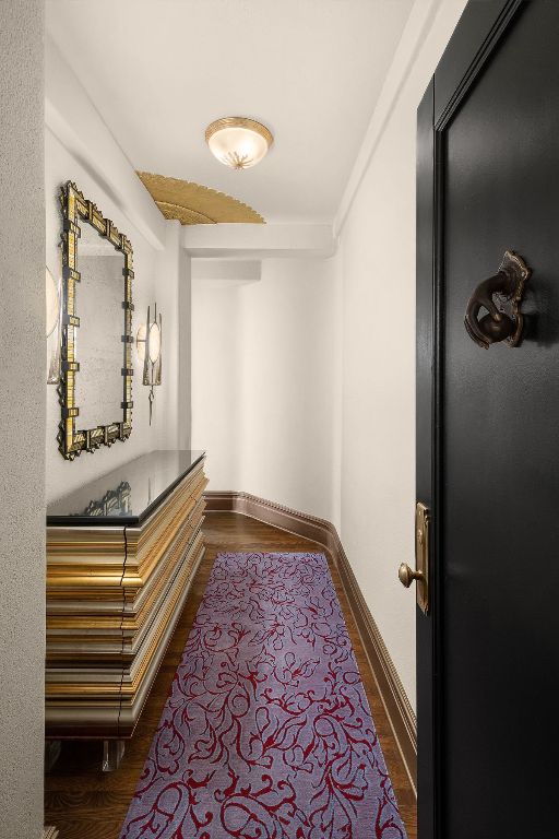 corridor with dark hardwood / wood-style flooring