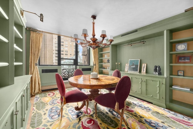 dining area with built in features and a chandelier