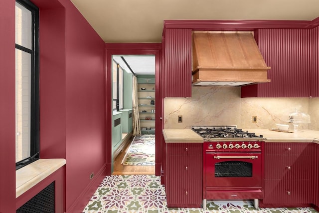 kitchen featuring decorative backsplash, stainless steel gas cooktop, and custom exhaust hood