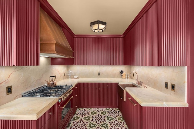 kitchen featuring tasteful backsplash, sink, high end stainless steel range oven, custom range hood, and wood counters