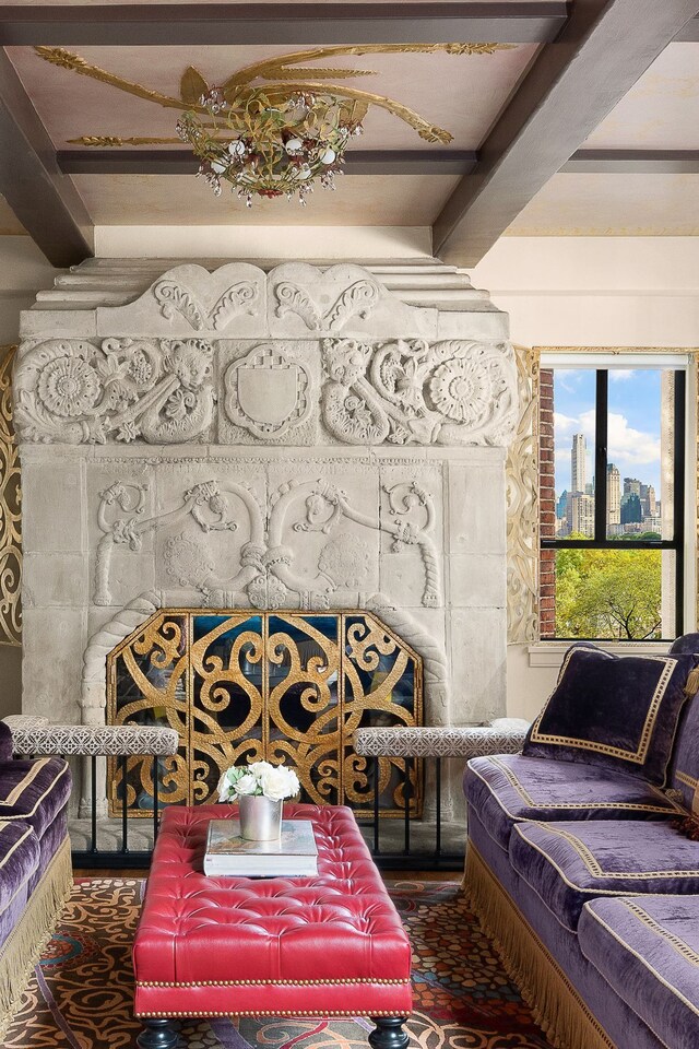 living area with coffered ceiling and beamed ceiling