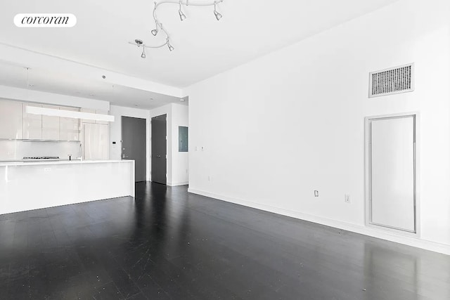 unfurnished living room featuring baseboards and visible vents