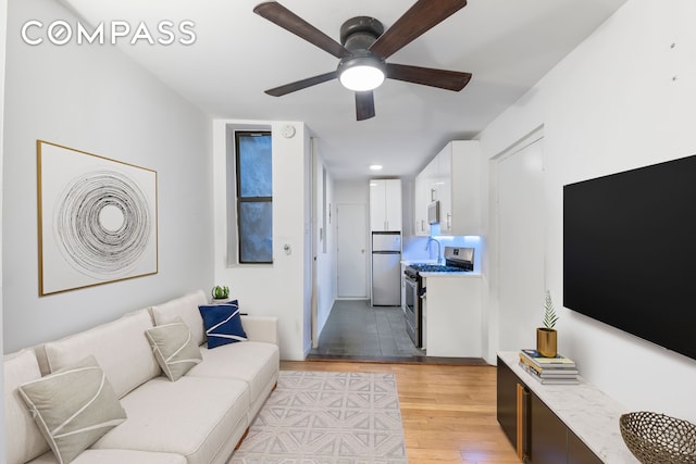 living room featuring recessed lighting, light wood-style floors, and ceiling fan