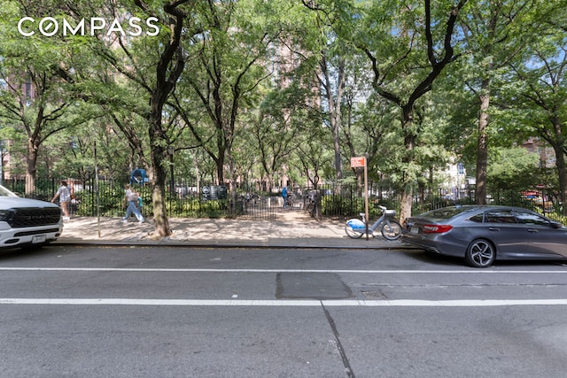 view of parking / parking lot with fence