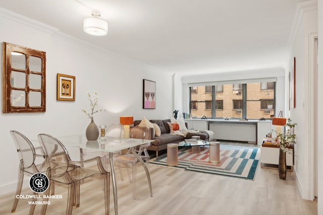 living room with crown molding and light hardwood / wood-style floors