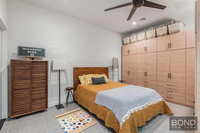 bedroom featuring brick wall and ceiling fan