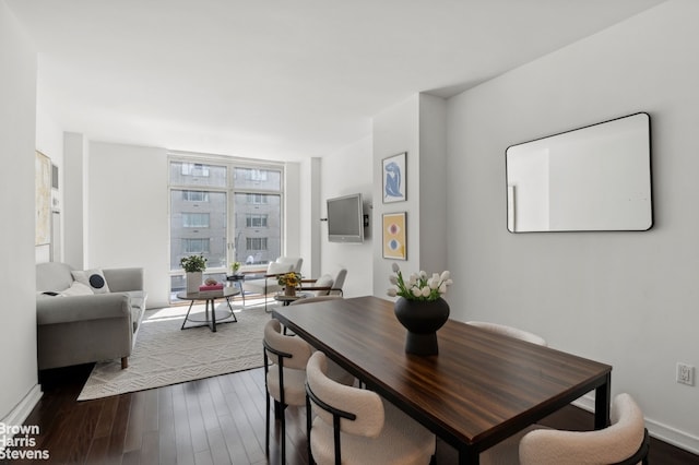 dining room featuring floor to ceiling windows and dark hardwood / wood-style flooring