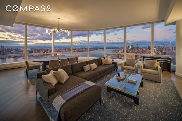 living area featuring a notable chandelier and a water view