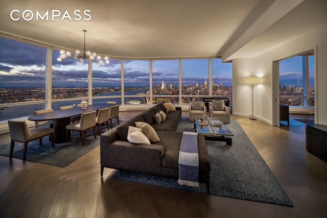 living area with an inviting chandelier, a view of city, and floor to ceiling windows