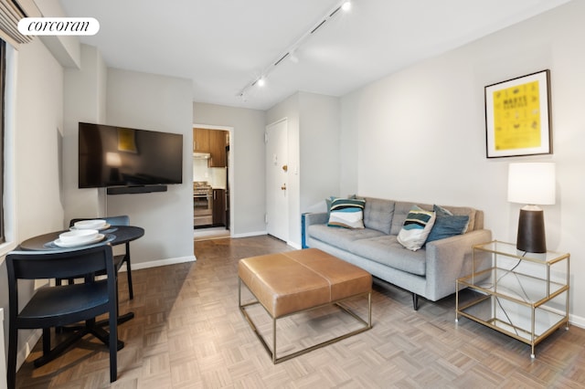 living room with light parquet flooring and track lighting