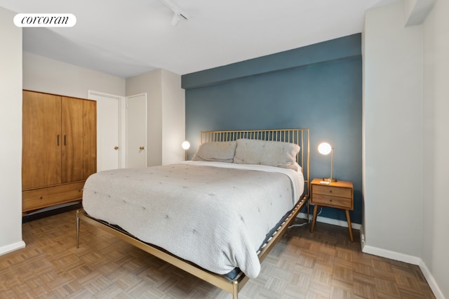 bedroom featuring parquet flooring