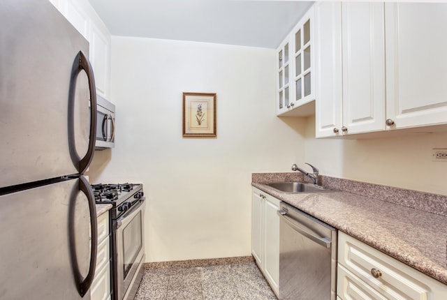 kitchen featuring stainless steel appliances, white cabinetry, and sink