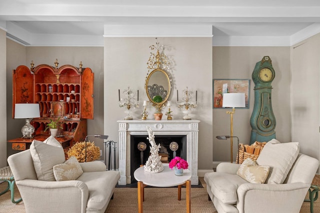 sitting room with a fireplace with flush hearth and baseboards