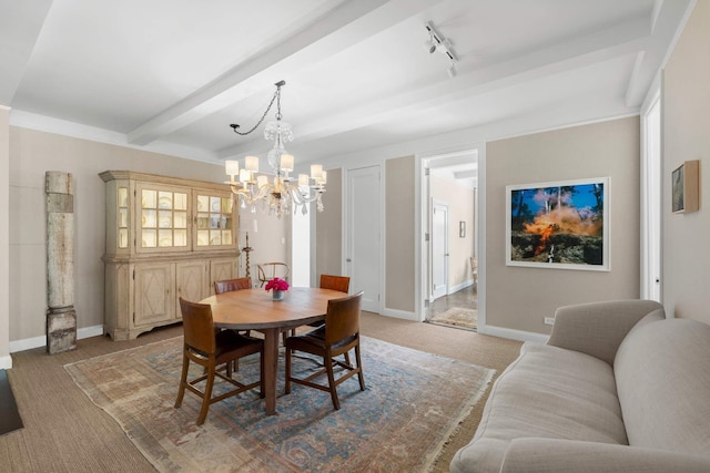 dining room with beam ceiling, light colored carpet, rail lighting, and baseboards